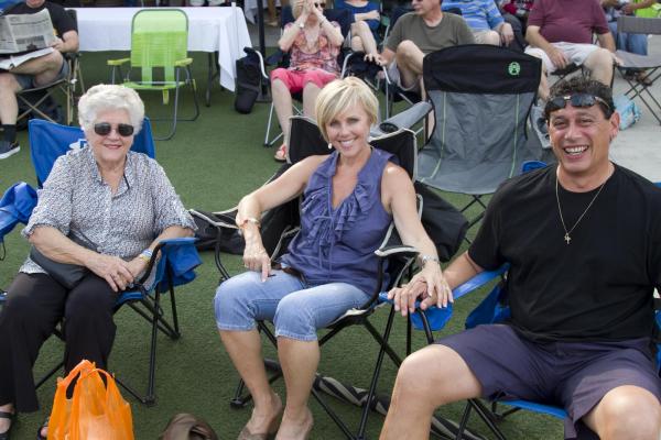 Miguel Bonano, Wendy Banister, Pam Goodhew from Raleigh enjoy the North Hills Midtown Music: Beach Music Series