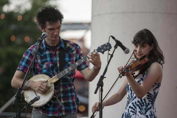 From left: Adam Hurt and Stephanie Coleman perform during Back Porch Music on the Lawn Series at American Tobacco Campus.