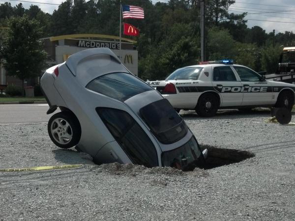 Car nosedives into sinkhole in Durham