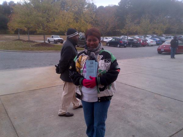Poll worker Nekel Satterfield shares her enthusiam at Durham County's Southern High School. 