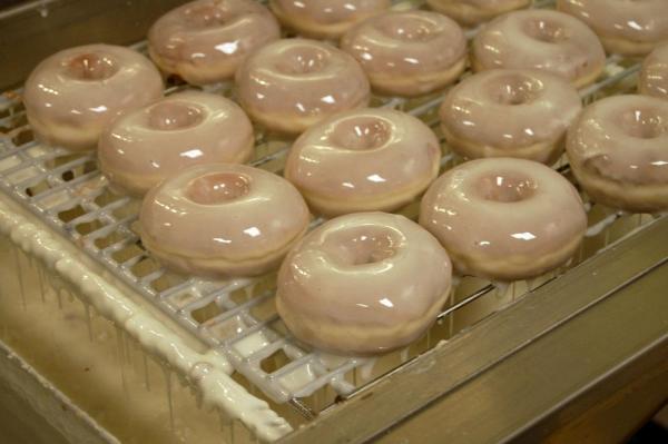 Chef Tom Ferguson glazes the doughnuts at Rise.