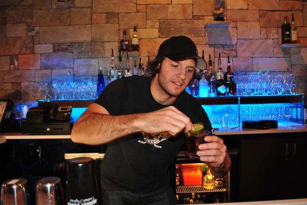 Former Carolina Hurricanes player Bates Battaglia serves up drinks at Zinda's first Celebrity Bartending event.