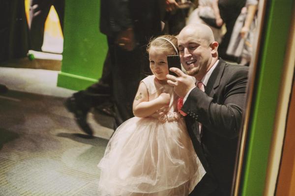 Paul Miles takes a photo with his daughter, Kayla, 3, at the Triangle Father-Daughter dance. Paul said it was his fourth time attending, as he had previously brought his 9-year-old daughter. "I come every year because there's a simple goodness about a father teaching his daughter how to be a good date," he said. "She learns to have a good time and to find the happiness of just being a little girl." 
