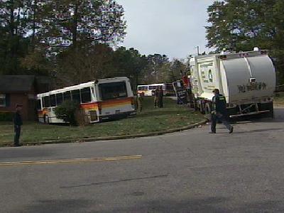 cat bus garbage truck collide