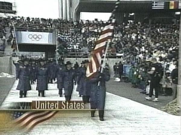 The U.S. delegation enters the stadium before a crowd of millions worldwide. 