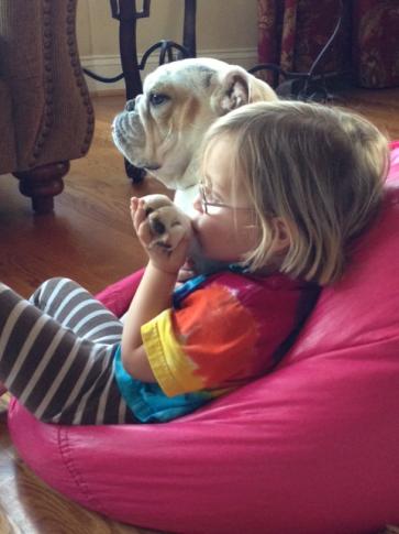 Sloane Heffernan's daughter gives Rosie, the dog, a kiss