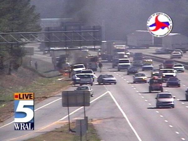 Traffic managed to keep moving as a vehicle went up in flames on the shoulder of I-40.(WRAL-TV5 News)