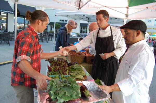 Team Mia Francesca buys supplies during the Iron Chef Challenge at the Midtown Farmers' Market on Sept. 27, 2014. 