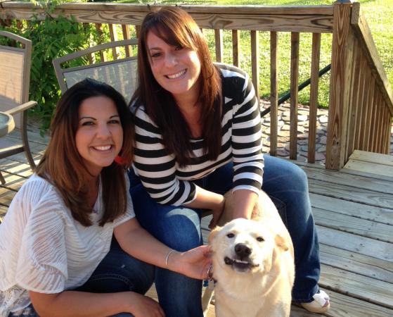 Marissa Piner, left, smiles with her roommate Doria Zarfaty and their dog Ace. Ace, formerly known as Freedo, was returned to the Wake County Animal Center four times before Piner and Zarfaty adopted him. (Photo courtesy of Marissa Piner)