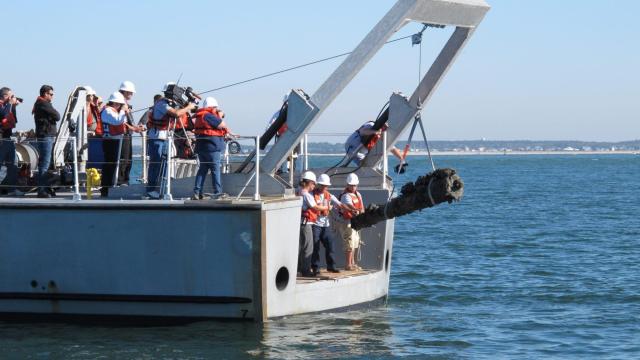 A NOAA vessel crew raises one of the 6-pound guns from Blackbeard's flagship Queen Anne's Revenge in the Beaufort inlet in October 2011 (Tyler Dukes/WRAL).