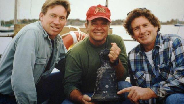 Ray Giroux, Mike Daniel and Capt. Walter Matheson hold a bell recovered from the Queen Anne's Revenge on Nov. 21, 1996 (Courtesy of Ray Giroux).