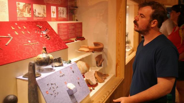 Clayton Durham, of Elon, N.C., views a collection of artifacts recovered from the Queen Anne's Revenge, flagship of the pirate Blackbeard (Tyler Dukes/WRAL).
