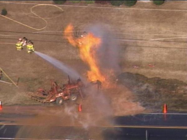 Flames from a ruptured gas line shoot into the air near Jones Franklin Road Monday.(WRAL-TV5 News)