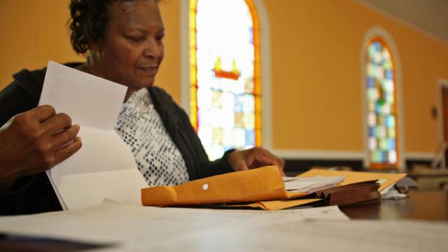 Yadkin Grove Baptist Church Deacon Osheatia Roberson thumbs through documents she's received about the quality of her church's well water (Tyler Dukes/WRAL).