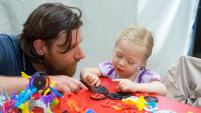 Jon Ladd plays with his daughter behind the booth at Artsplosure. Photos by: Carlton Bassett