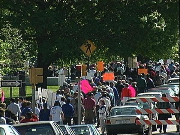 Protestors march in response to Gov. Hunt's announcement.