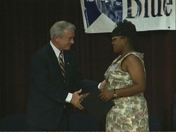 Governor Hunt presents a blue ribbon award to a deserving recipient