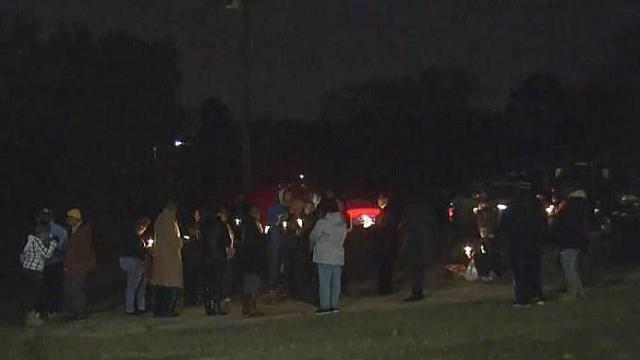 Vigil unites police with families of suspect, victim in Fayetteville stabbing