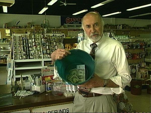 Tom Lawrence displays a collection bucket at a local hardware store