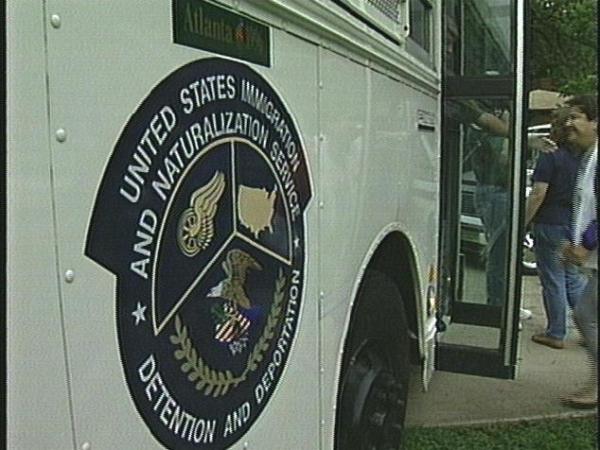 An INS bus takes 17 immigrants busted in a slave labor ring to Charlotte