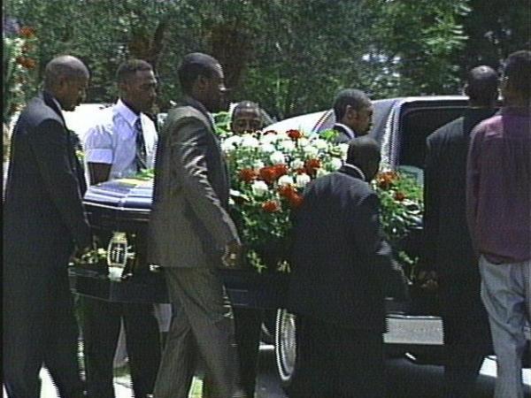 Pallbearers carry the casket of the late Clayton Chesson