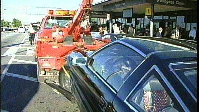 A tow truck moves a 280ZX from a no parking zone at the RDU Airport. (WRAL-TV)