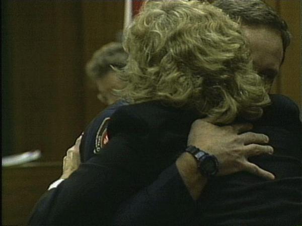 Officer Cleary hugs his wife after the verdict is read.