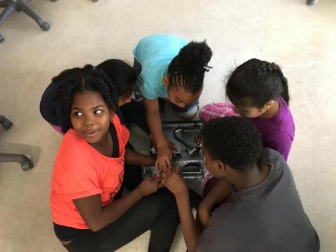 Eastway third grade student Kayden works with her classmates to disassemble a computer.
Photo by : Jess Clark / WUNC
