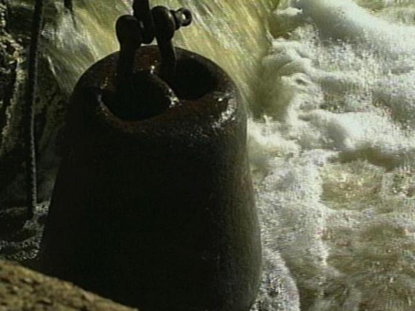 A wrecking ball is brought in to break up the dam.