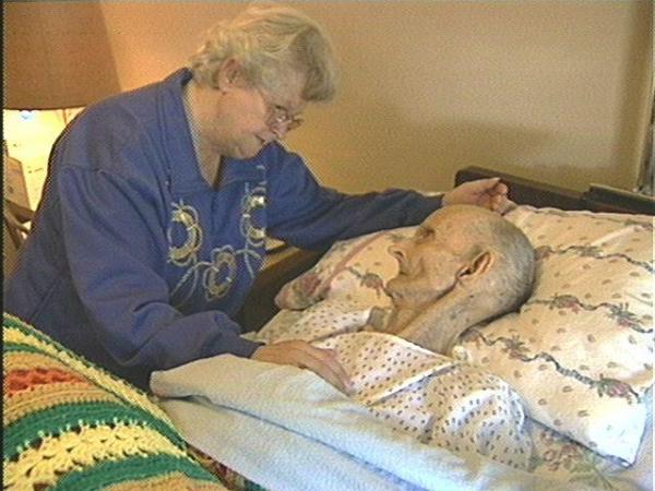 Norma Jean Gunter sits at the bedside of her father, 100-year-old Franze Gonella, the victim of abuse at the hands of his caregiver.