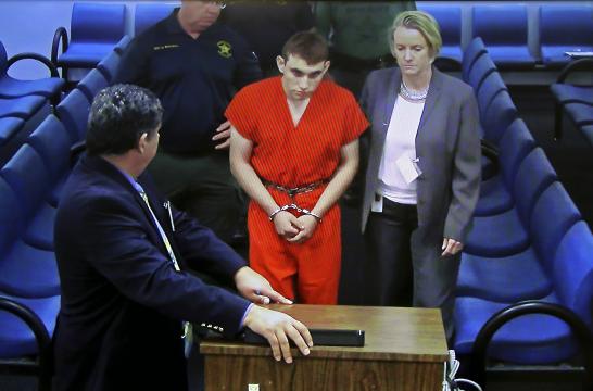 Nikolas Cruz, the suspected gunman in one of the deadliest school shootings in modern American history, appears in court in Fort Lauderdale, Fla., via video conference on Thursday, Feb. 15, 2018. Cruz, 19, faces 17 counts of premeditated murder -- one for each of the people he killed with a semiautomatic AR-15 rifle at Marjory Stoneman Douglas High School in Parkland, Fla., on Wednesday. (Susan Stocker/Pool via The New York Times) -- FOR EDITORIAL USE ONLY --
