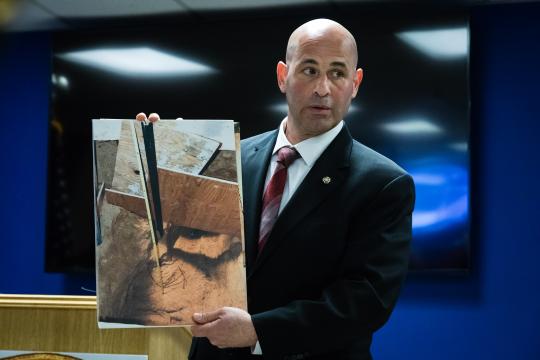 Chief of Detectives Gerard Gigante of the Suffolk County Police Department with a photo showing where remains were found during a news conference, in Yaphank, N.Y., March 20, 2017. After more than half a century, investigators believe they may have found the remains of Louise Pietrewicz, who disappeared in 1966, buried under the home of a police officer with whom she had a romantic relationship. (Heather Walsh/The New York Times)