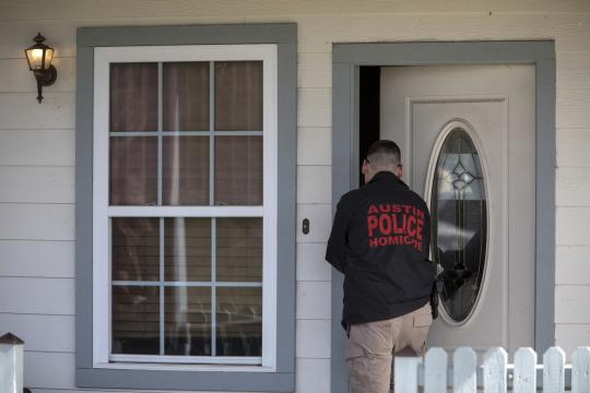 A police officer enters the home of the parents of Austin bombing suspect Mark Anthony Conditt in Pflugerville, Texas, March 21, 2018. Authorities had identified Conditt, who blew himself up, via surveillance footage and other clues, the authorities said. (Tamir Kalifa/The New York Times)