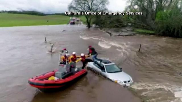 Raw: Crews pull CA driver from vehicle, swollen creek