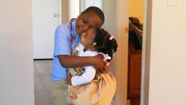 Jayden, 9, gives his sister Mia, 3, a hug as they welcome visitors to their new home in Ahoskie. Shavonda Smith says her two children were helpers as the three-bedroom house was being built on Deer Circle.