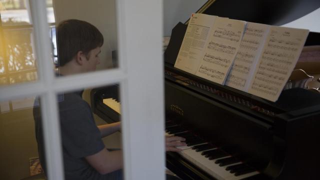Adaline's brother Stewart, 14, takes his turn showing his musical skills.  "I don't expect any of my children to become professional musicians," Linda Simpson said. "But having a musical talent is often a hobby that allows a person to handle a high stress job later in life."