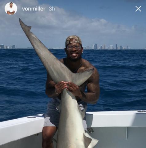 Von Miller posing with a shark