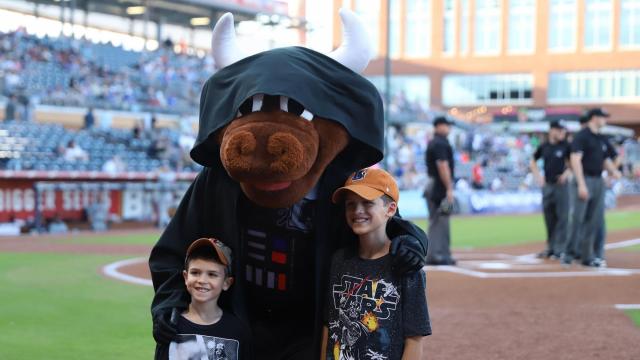 Darth Wool E. Bull poses with fans. The Durham Bulls held Star Wars Night on May the 4th, 2018 at the Durham Bulls Athletic Park. (Jerome Carpenter/WRAL Contributor)