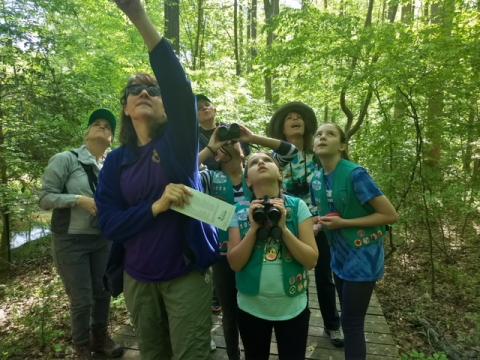 Kim Brand of Audubon North Carolina (far left) and Tamara Barringer, R-Wake, (second from right) go birdwatching at Hemlock Bluffs Nature Preserve with a Girl Scout troop.