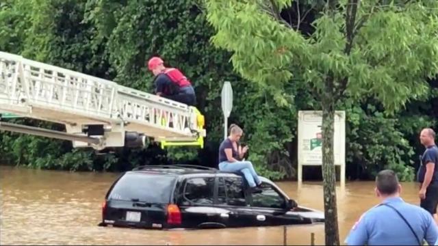 Firefighters rescue woman sitting on top of car after getting stuck in Raleigh floodwaters 