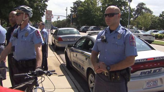 Raw: Person taken away from monuments meeting in police car