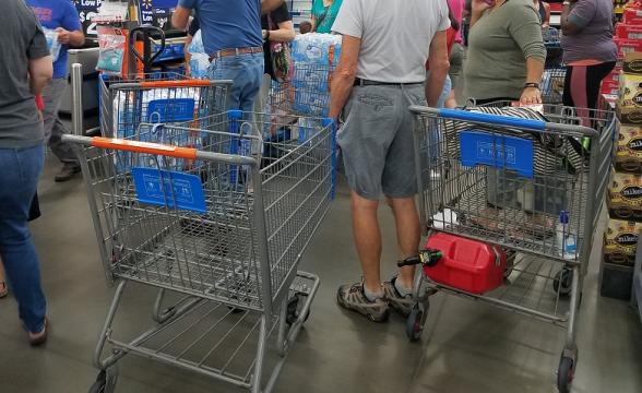 Customers crowding around pallet of bottled water near Clayton, NC 9-9-18