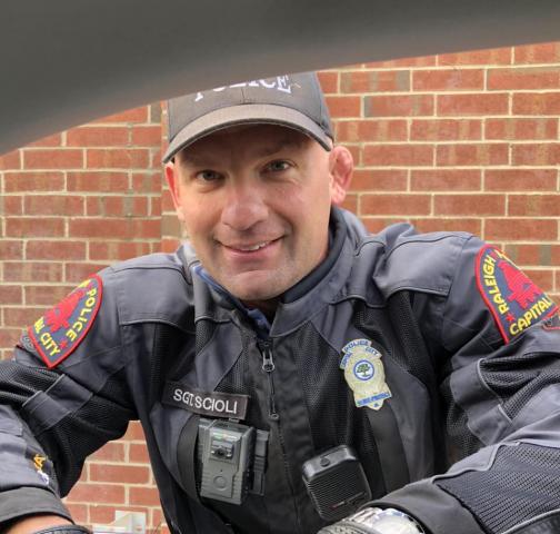Sgt. Brian Scioli changed a woman's tire while she was stuck on the side of I-440 on Thursday morning. Photo courtesy of Peggy Skirball. 
