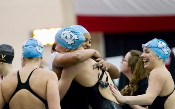 Candace Cooper with teammates during a swim competition.