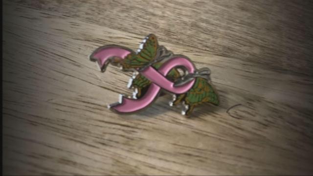 The two butterflies represent Blayde's twin two year old daughters entertwined with the breast cancer awareness ribbon