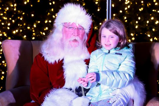 A young girl poses for a picture with Santa Claus. The Annual Christmas Tree Lighting Celebration was held in the Commons of North Hills in Raleigh, NC on November 23, 2019 (Jerome Carpenter/WRAL Contributor)