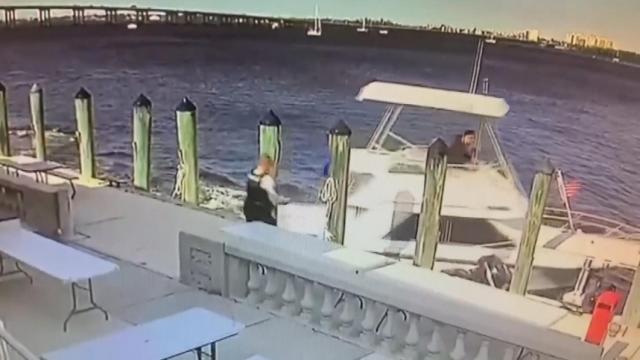 Close call: Officer leaps to safety seconds before boat crash