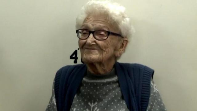 100-year-old Ruth Bryant smiles for her jail portrait