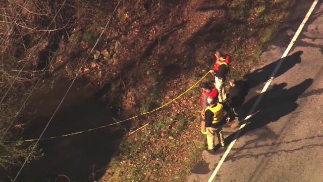 Raw: Crews pull car, woman from Angier creek