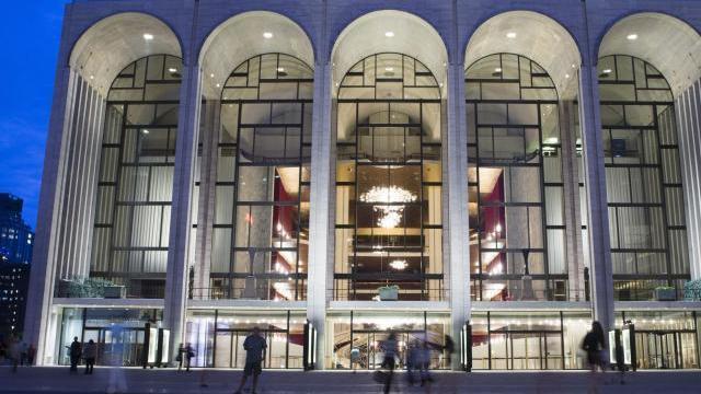 FILE - In this Aug. 1, 2014, file photo, pedestrians make their way in front of the Metropolitan Opera house at New York's Lincoln Center. (AP Poto/John Minchillo, File)